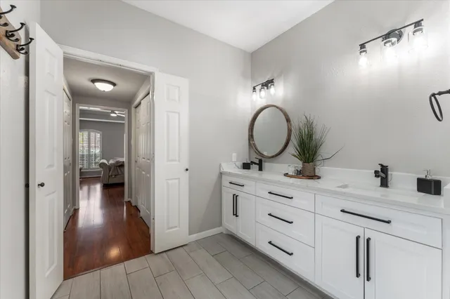 a bathroom with a double vanity sink and a mirror