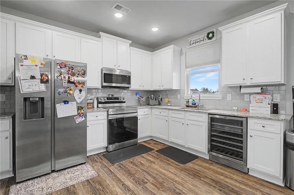 108 Mcginnis Circle Calhoun, GA 30701 - Photo 11 of 56 a kitchen with granite countertop a refrigerator stove and microwave