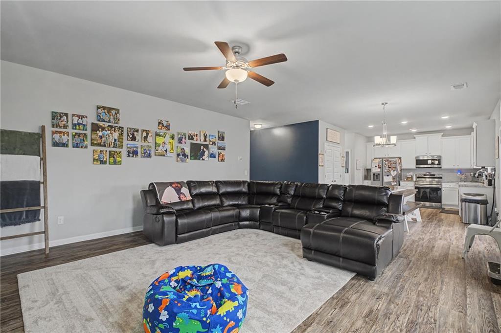 108 Mcginnis Circle Calhoun, GA 30701 - Photo 20 of 56 a living room with furniture and a wooden floor