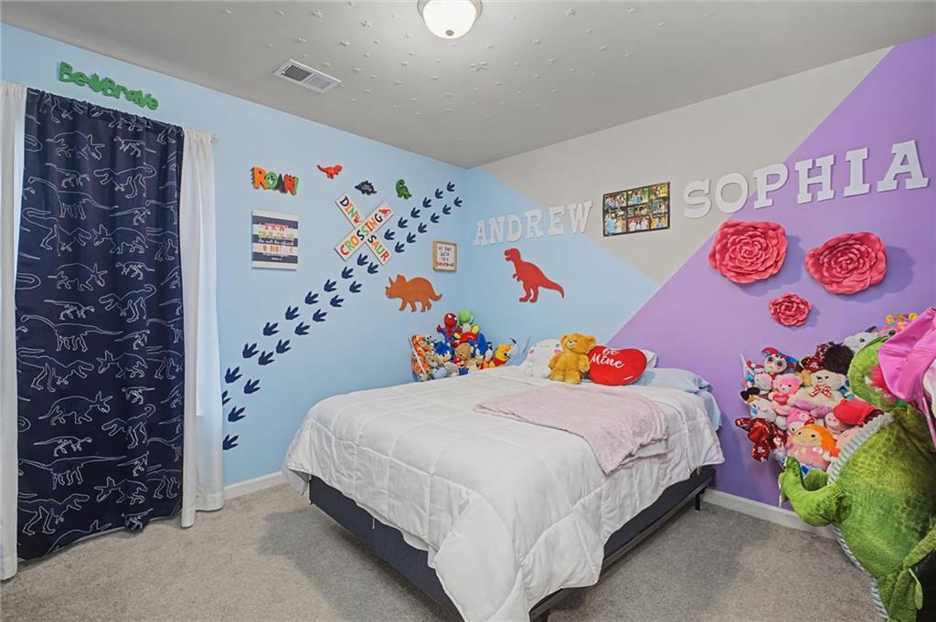 108 Mcginnis Circle Calhoun, GA 30701 - Photo 22 of 56 a bedroom with a bed and a plant