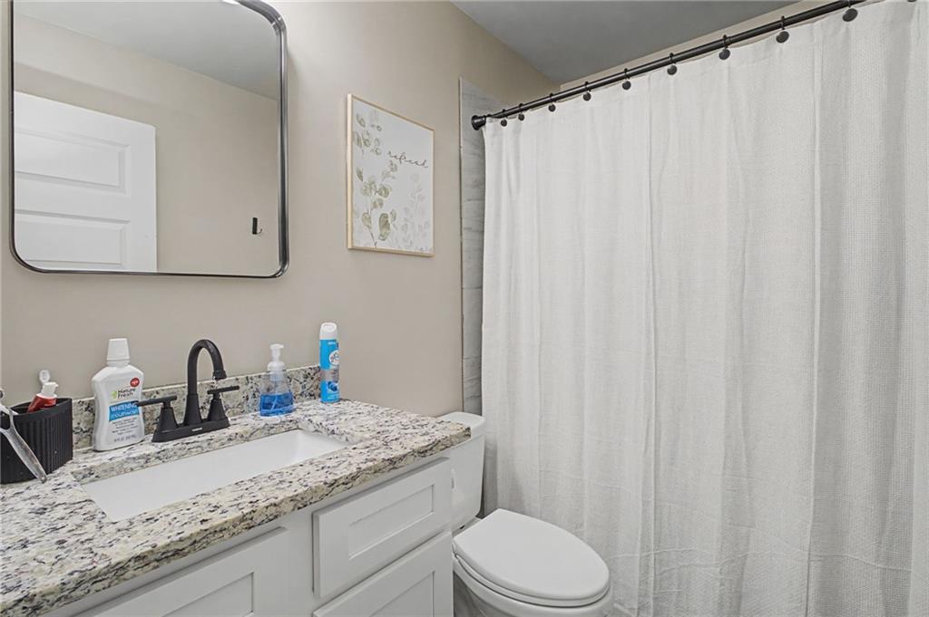 108 Mcginnis Circle Calhoun, GA 30701 - Photo 27 of 56 a bathroom with a granite countertop sink and a mirror