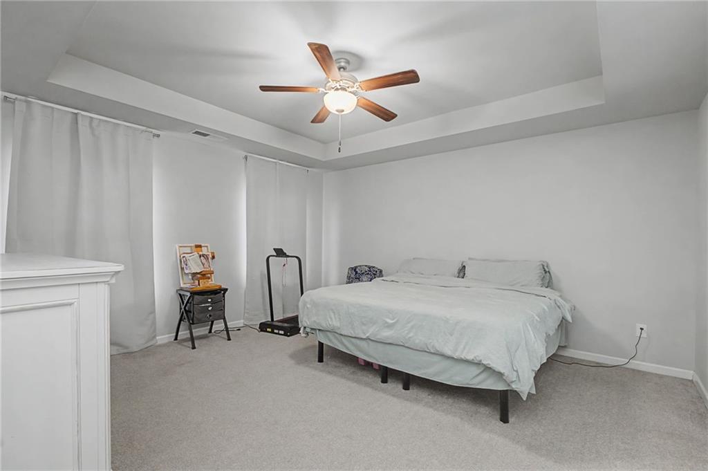 108 Mcginnis Circle Calhoun, GA 30701 - Photo 31 of 56 a bed room with a bed and a ceiling fan