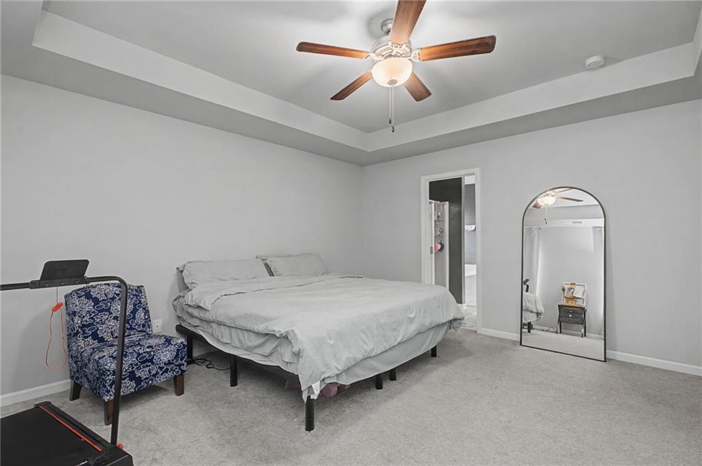 108 Mcginnis Circle Calhoun, GA 30701 - Photo 32 of 56 a spacious bedroom with a bed and a chandelier
