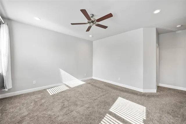 an empty room with closet and windows