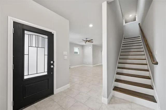 a view of a hallway with windows and stairs