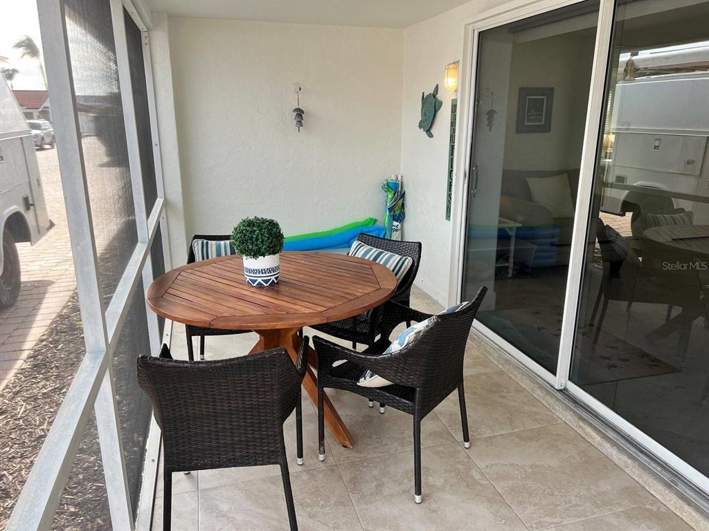 6154 Midnight Pass Road, Unit A04 Sarasota, FL 34242 - Photo 15 of 15 a view of a dining room with furniture