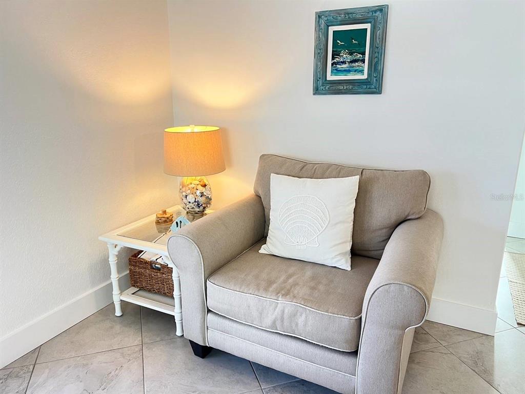 6154 Midnight Pass Road, Unit A04 Sarasota, FL 34242 - Photo 5 of 15 a bedroom with a bed and a couch