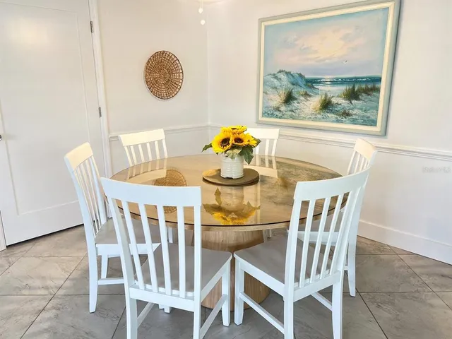 a dining room with furniture and window