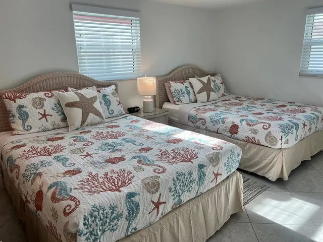 a bedroom with a bed lamp and a window