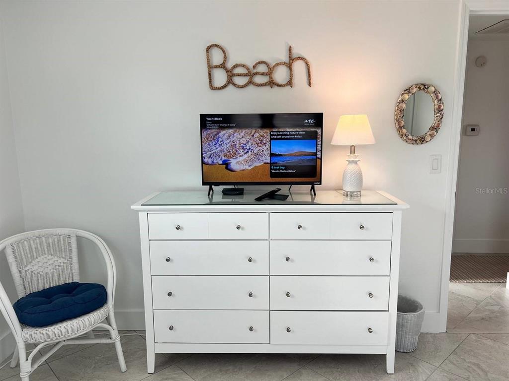 6154 Midnight Pass Road, Unit A04 Sarasota, FL 34242 - Photo 8 of 15 a room with a cabinet and a mirror