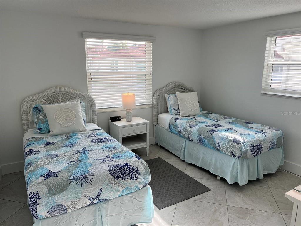 6154 Midnight Pass Road, Unit A04 Sarasota, FL 34242 - Photo 9 of 15 a bedroom with a bed and a window