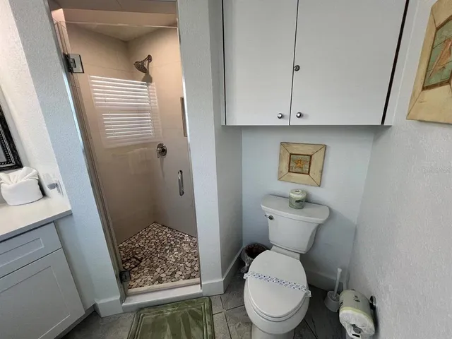a bathroom with a toilet and a shower