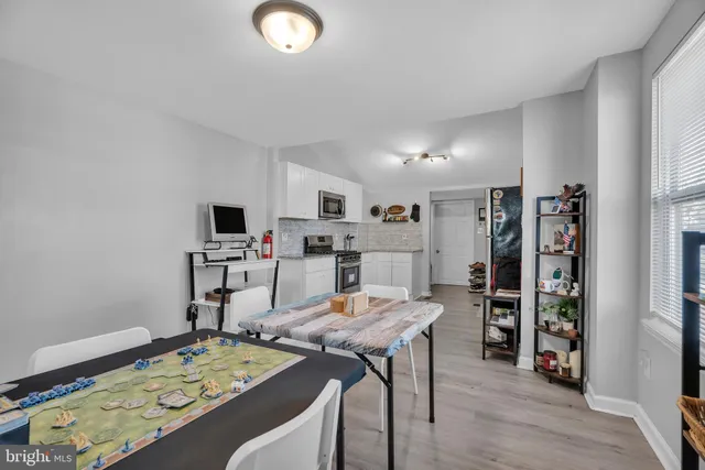 a view of a livingroom with workspace and a window