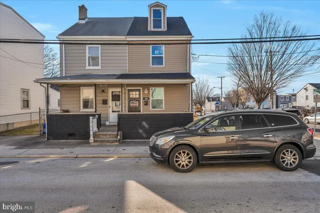 a view of a car parked in front of a house