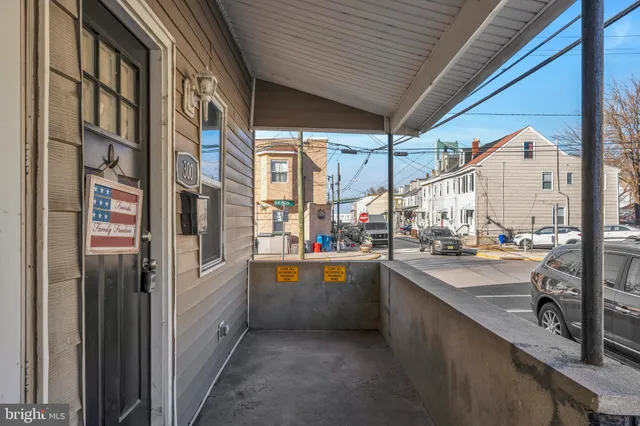 a room with stainless steel appliances kitchen island granite countertop a refrigerator and a sink