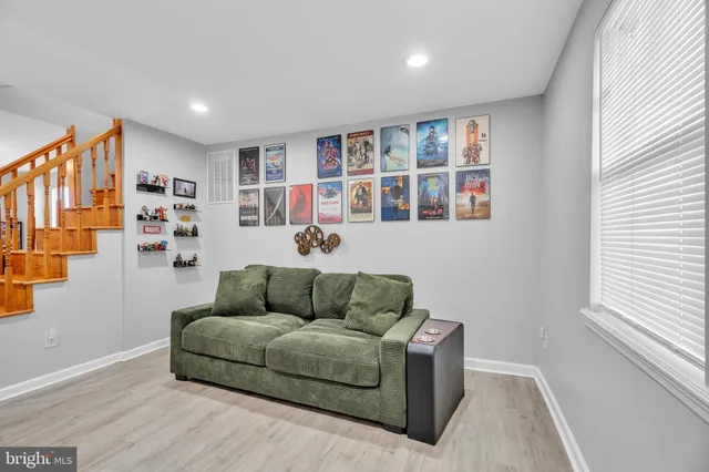 a living room with furniture and book shelf