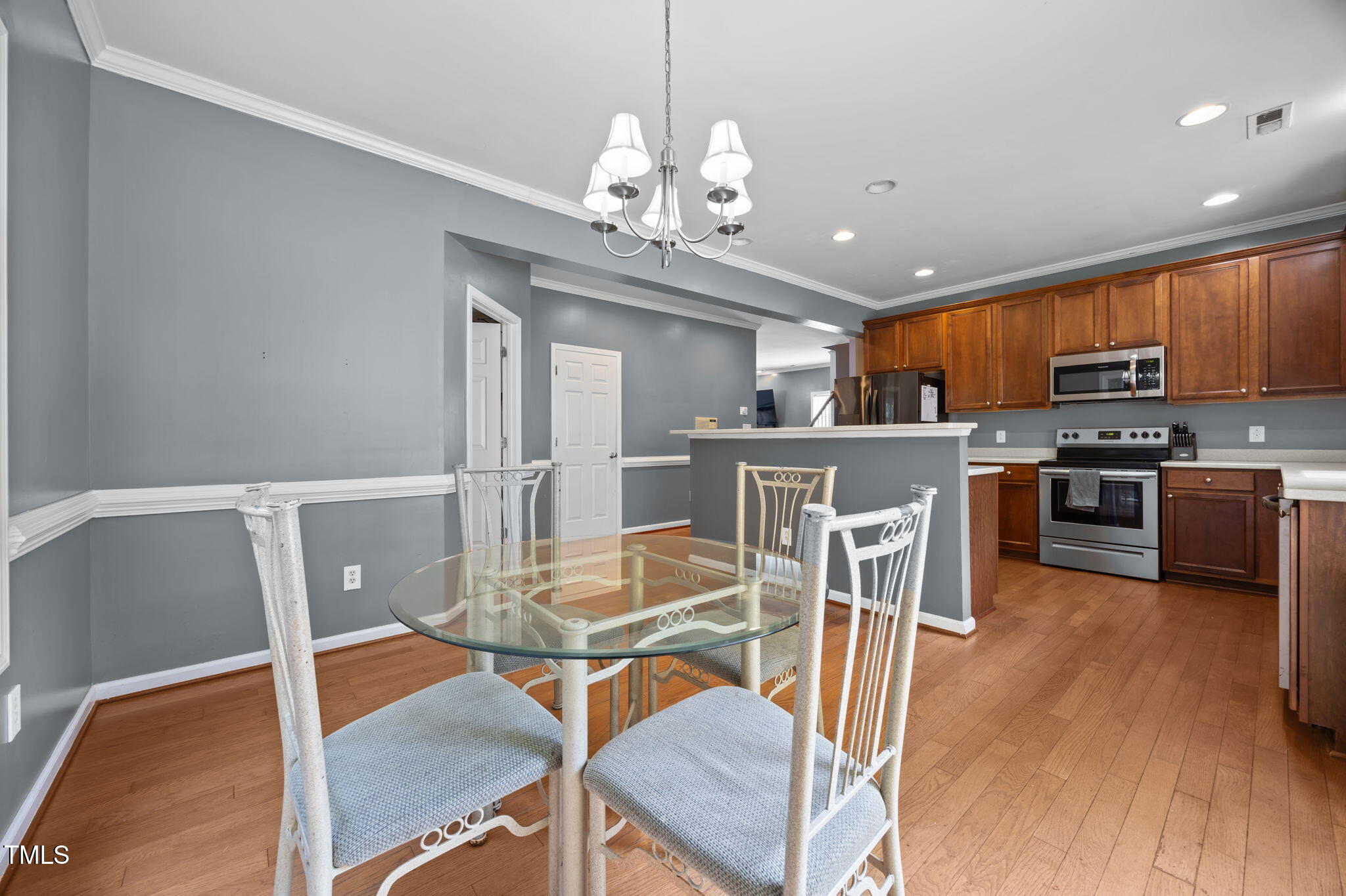 2310 Shepherd Valley Street Raleigh, NC 27610 - Photo 7 of 27 a view of a dining room with furniture and wooden floor