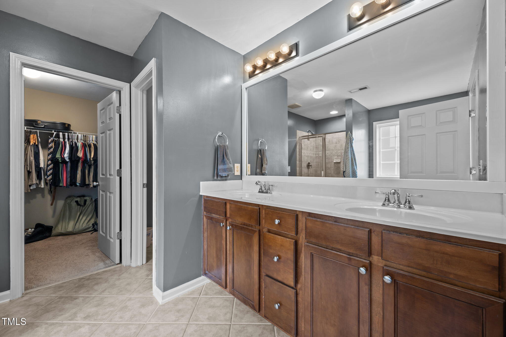 2310 Shepherd Valley Street Raleigh, NC 27610 - Photo 11 of 27 a bathroom with a double vanity sink and a mirror