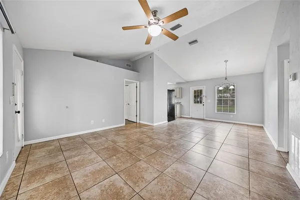 a view of an empty room with a ceiling fan