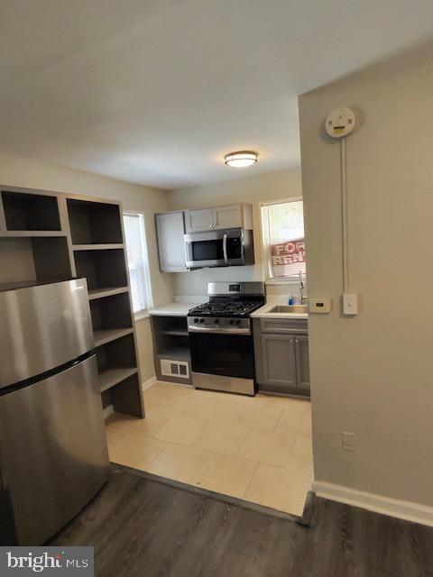 4778 South Capitol Terrace Southwest, Unit C Washington, DC 20032 - Photo 5 of 12 a kitchen with stainless steel appliances a stove a microwave and a refrigerator