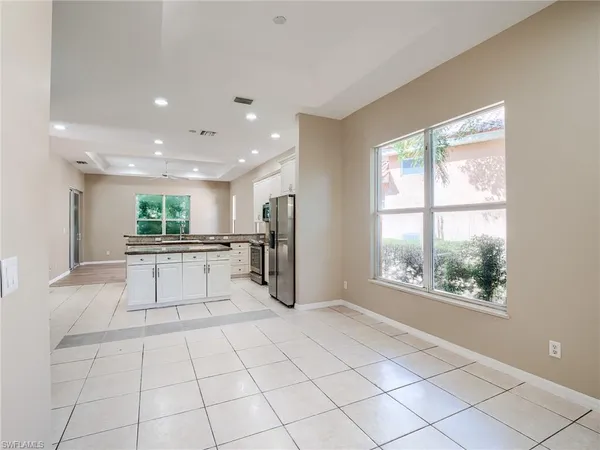 a view of a kitchen with kitchen appliances and windows
