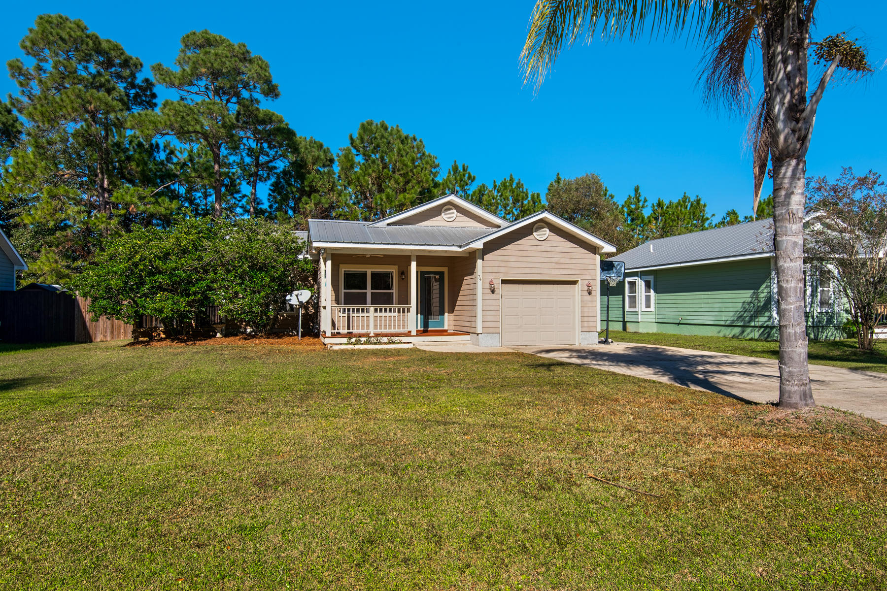74 Garden Street Santa Rosa Beach, FL 32459 - Photo 1 of 43 a view of a house with a backyard and a tree