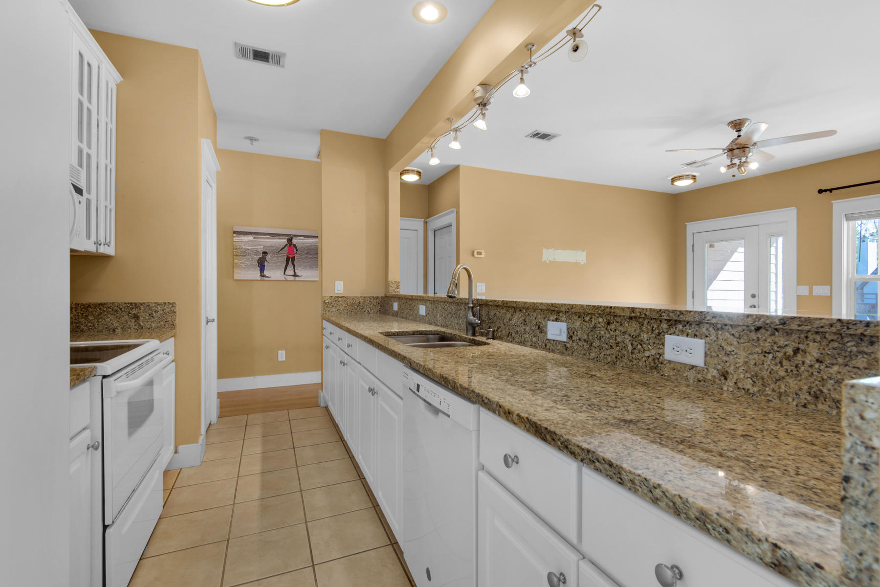 74 Garden Street Santa Rosa Beach, FL 32459 - Photo 14 of 43 a large kitchen with granite countertop a sink and a stove top oven