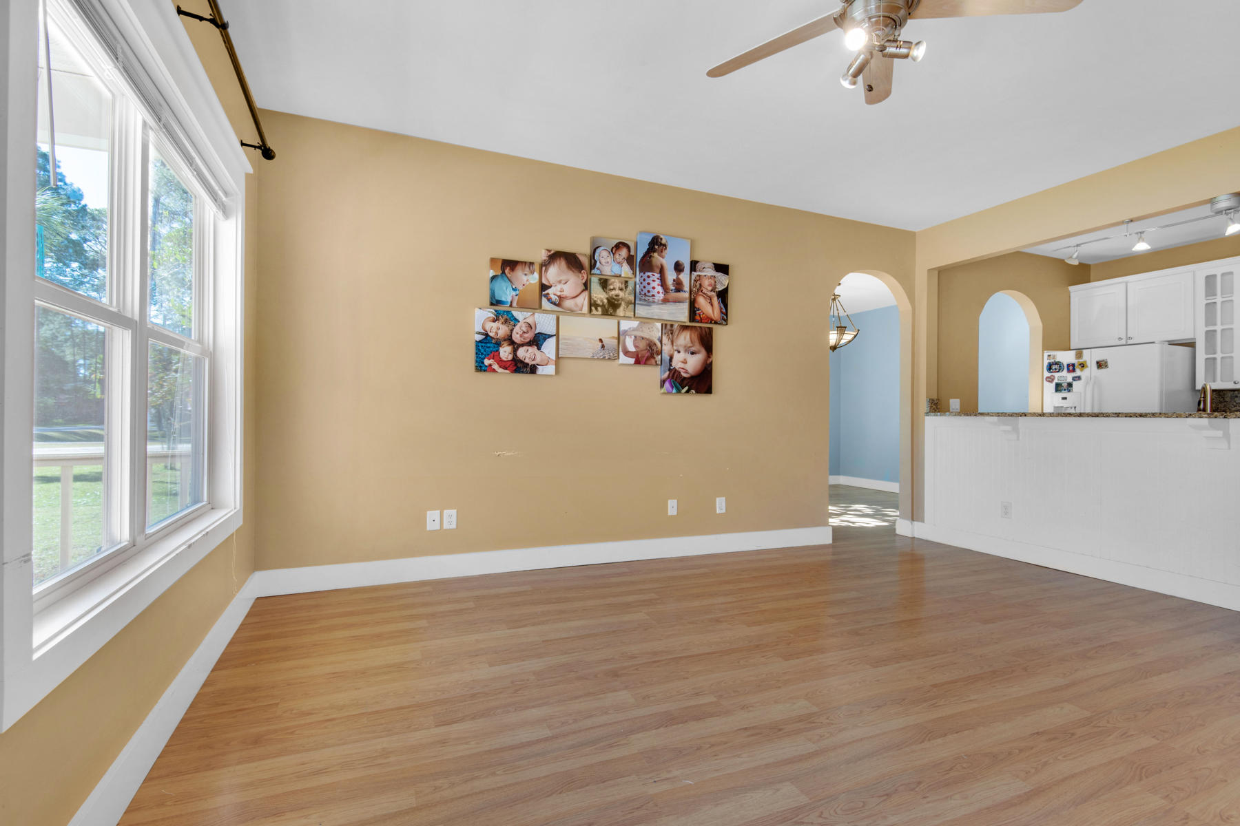 74 Garden Street Santa Rosa Beach, FL 32459 - Photo 3 of 43 a view of a livingroom with wooden floor and a ceiling fan