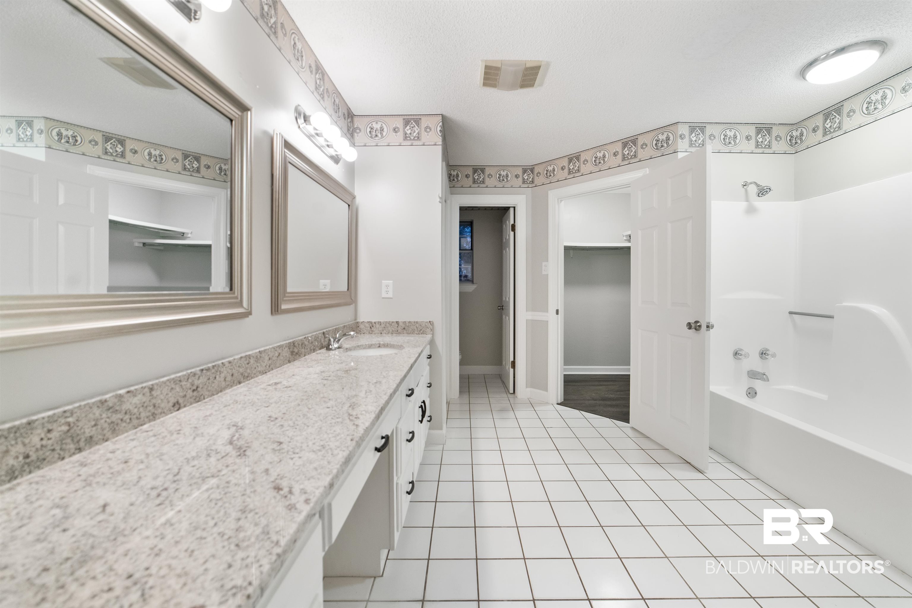 11833 Old Moffat Road Wilmer, AL 36587 - Photo 8 of 23 Bathroom with shower / bath combination, visible vents, tile patterned floors, a textured ceiling, and vanity