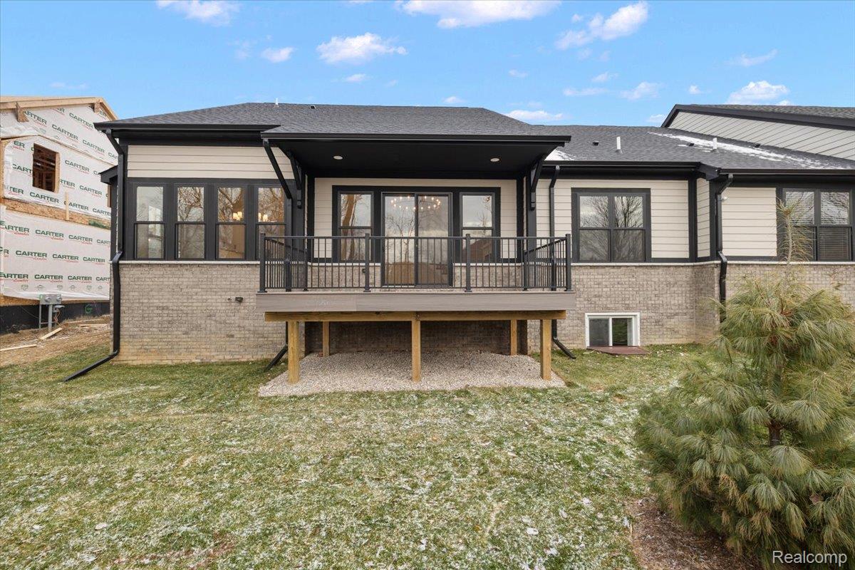 2044 Breckenridge Court Rochester, MI 48309 - Photo 7 of 33 Rear view of property featuring a sunroom, a wooden deck, brick siding, and a yard