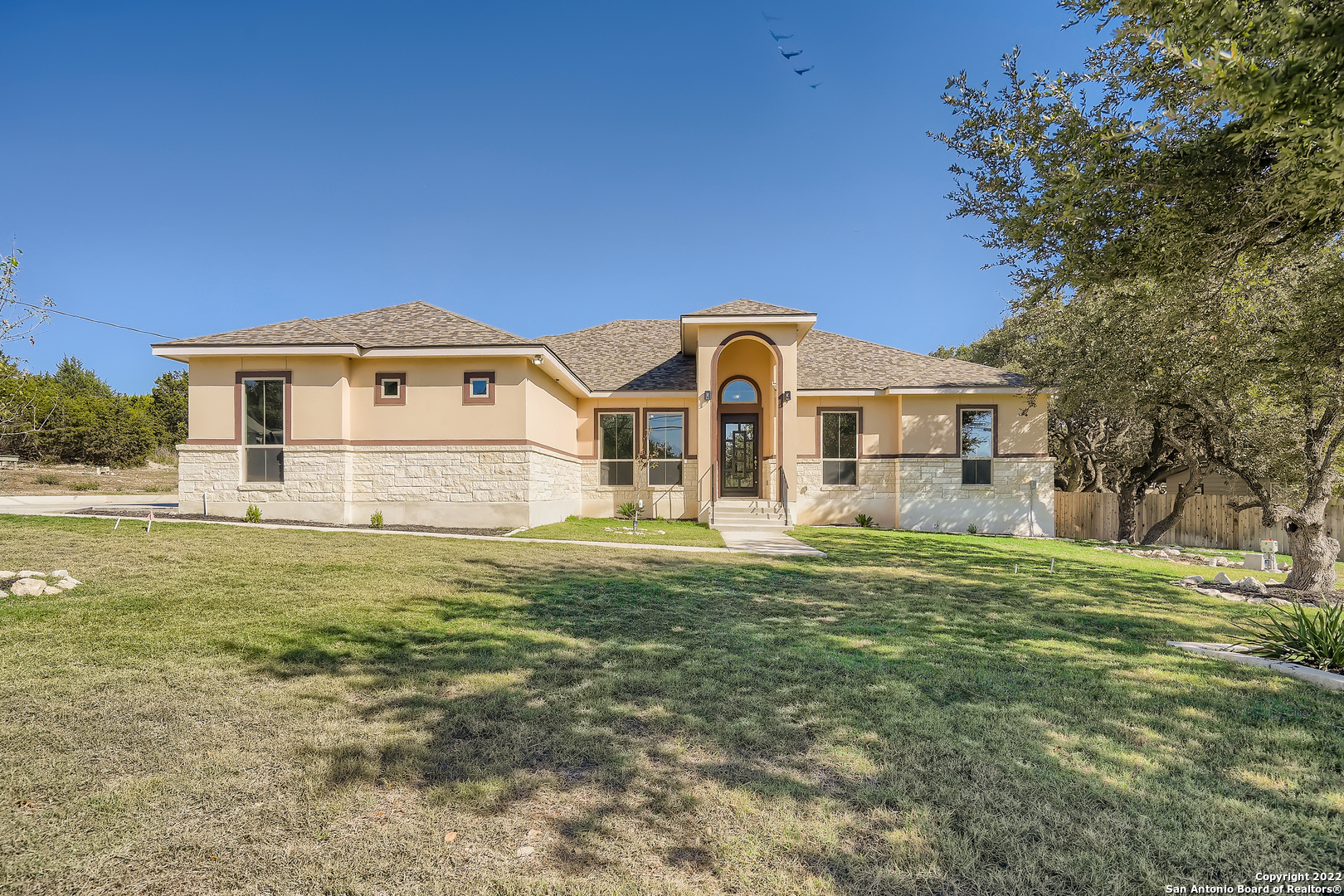 a front view of a house with a garden