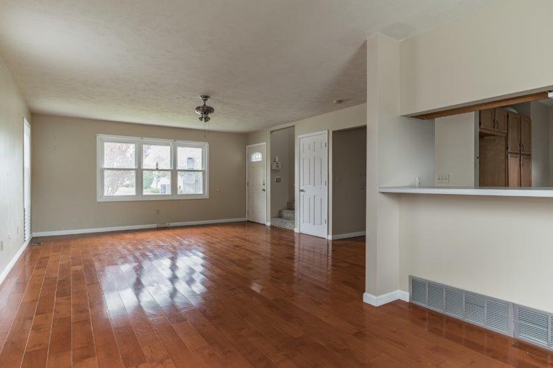 405 Meridian Drive Springfield, IL 62702 - Photo 14 of 26 an empty room with wooden floor and windows
