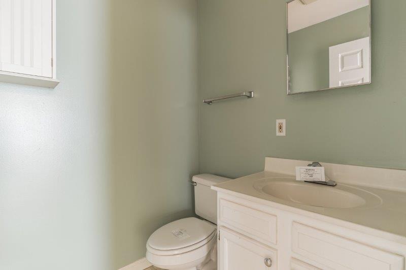 405 Meridian Drive Springfield, IL 62702 - Photo 25 of 26 a bathroom with a toilet sink vanity and mirror