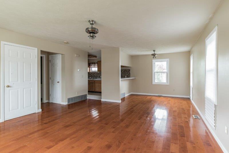 405 Meridian Drive Springfield, IL 62702 - Photo 6 of 26 a view of an empty room with window and wooden floor