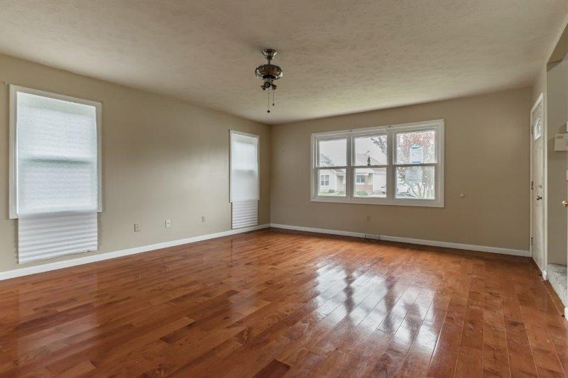 405 Meridian Drive Springfield, IL 62702 - Photo 7 of 26 a view of an empty room with a window and wooden floor