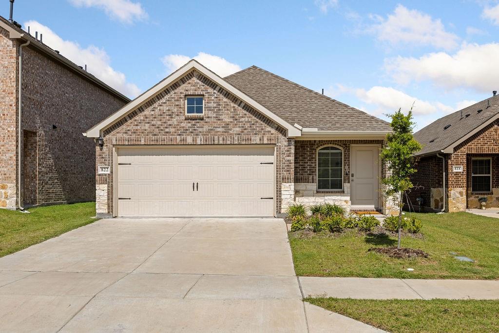 822 Ramble Road Lavon, TX 75166 - Photo 1 of 35 Brick and stone facade featuring a single-car garage with a concrete driveway