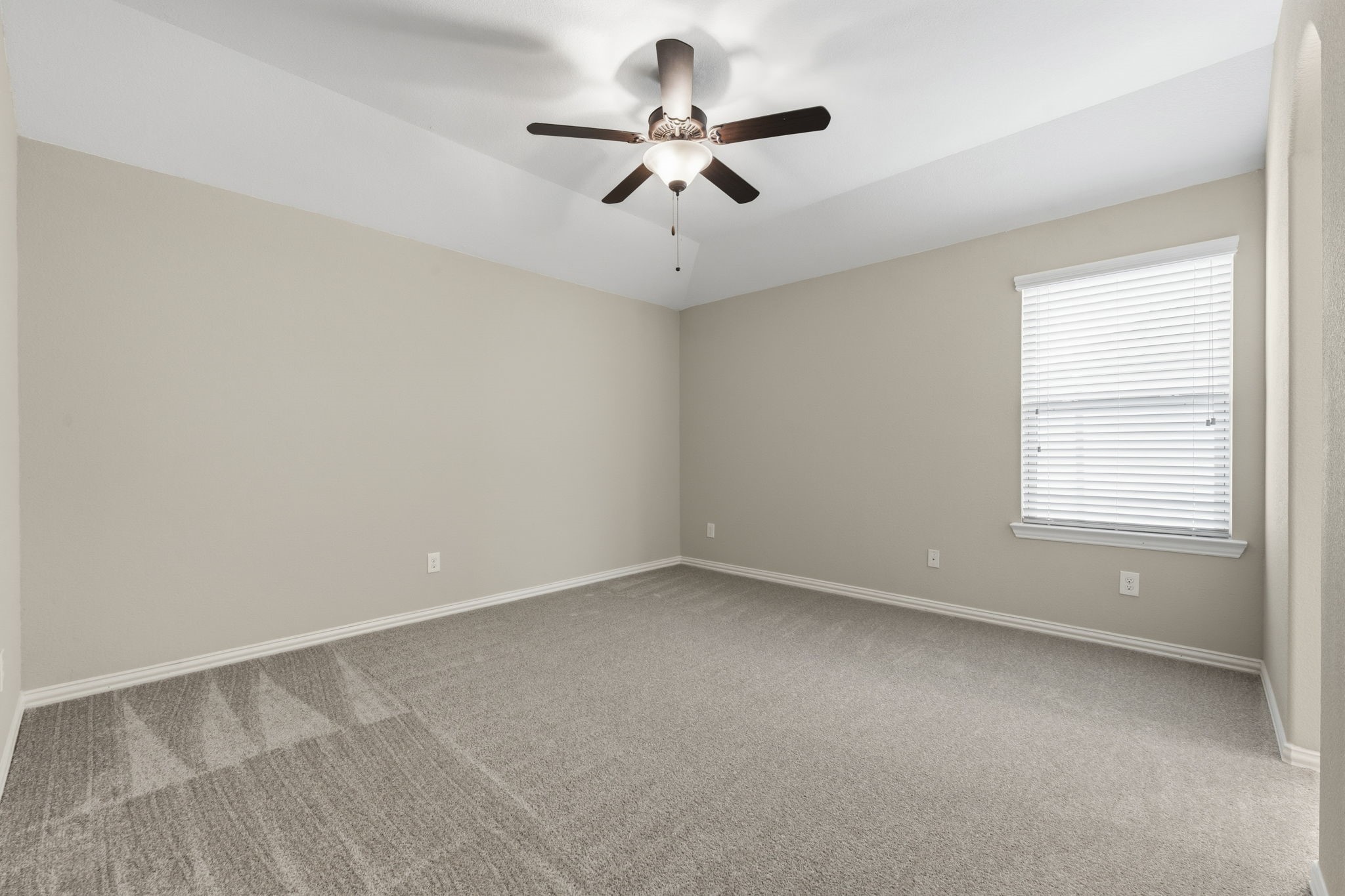 25210 Gaddis Oaks Drive Spring, TX 77389 - Photo 33 of 50 an empty room with a window and a ceiling fan