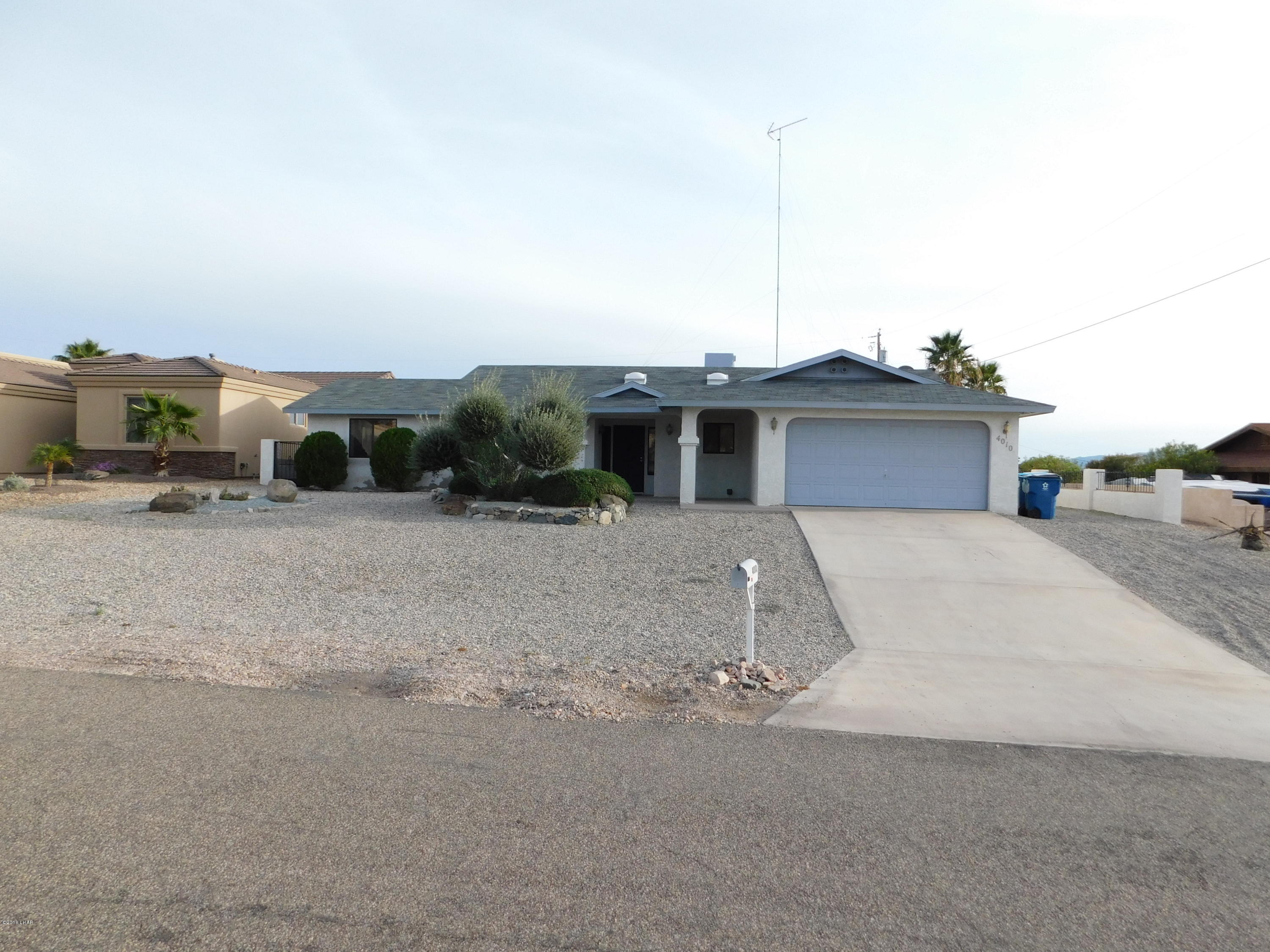 4010 Bluegrass Drive, Unit R Lake Havasu City, AZ 86406 - Photo 1 of 47 a front view of a house with a yard and garage