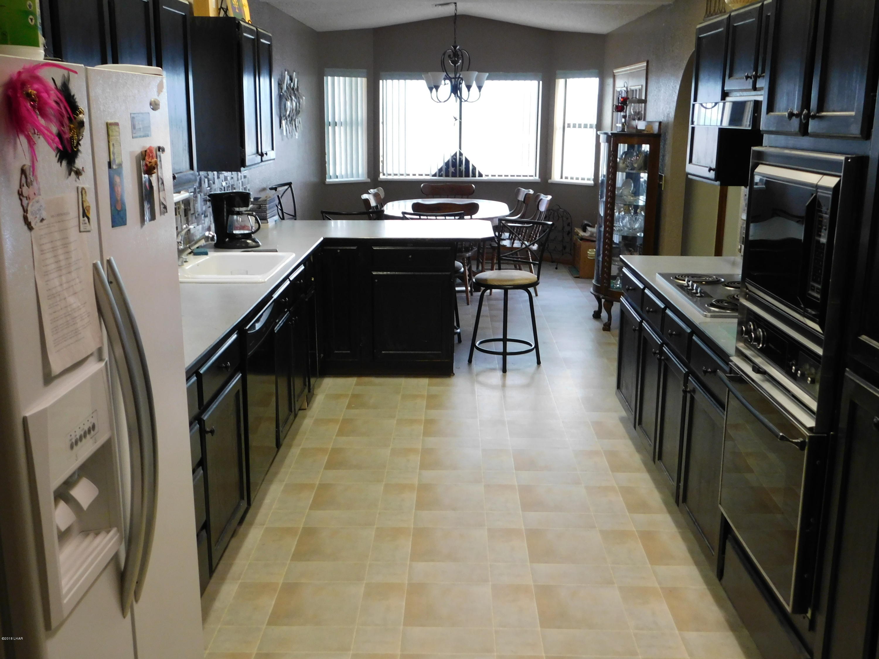 4010 Bluegrass Drive, Unit R Lake Havasu City, AZ 86406 - Photo 12 of 47 a kitchen with stainless steel appliances granite countertop a sink stove and refrigerator