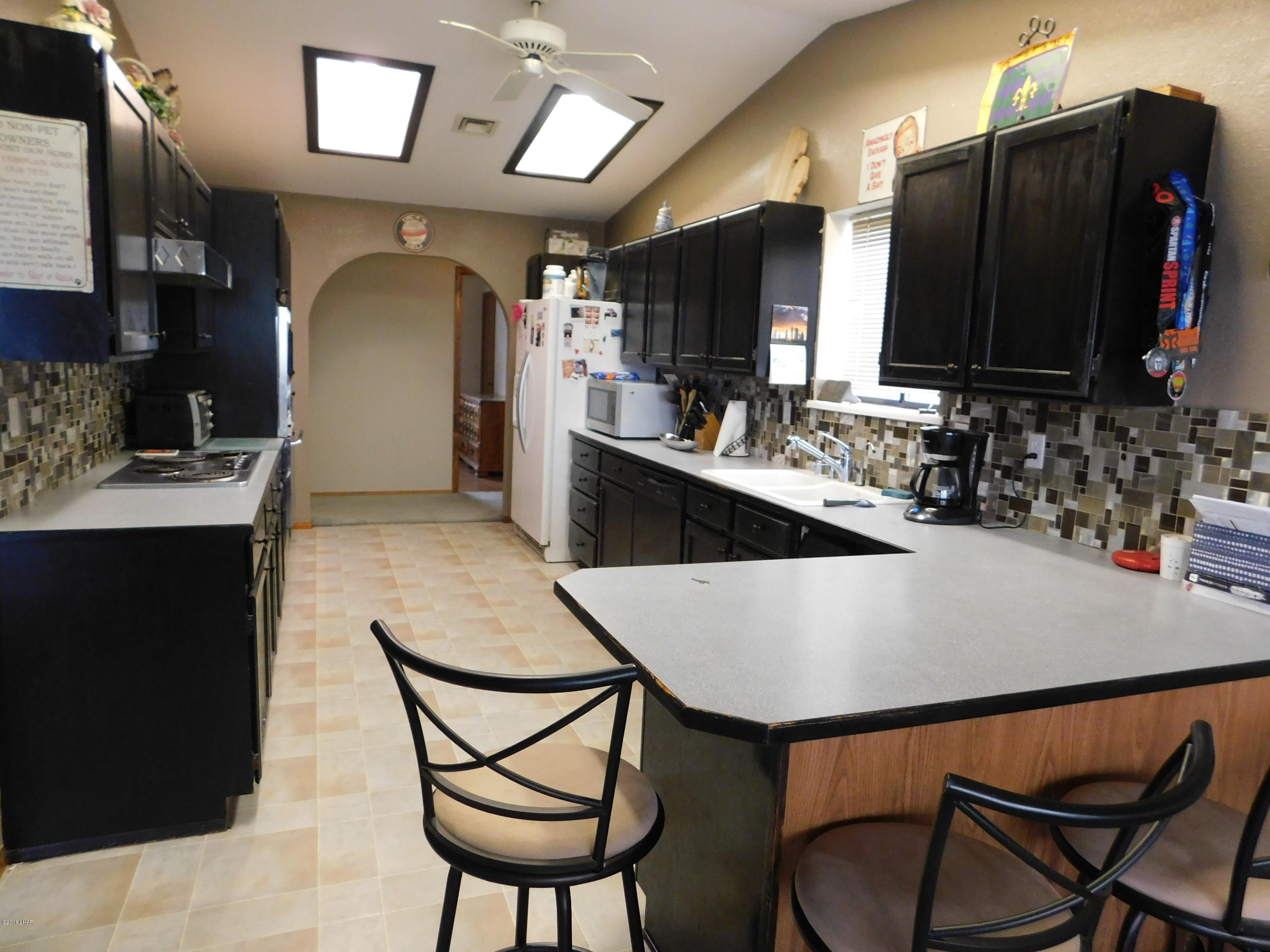 4010 Bluegrass Drive, Unit R Lake Havasu City, AZ 86406 - Photo 14 of 47 a view of kitchen island a sink and chairs
