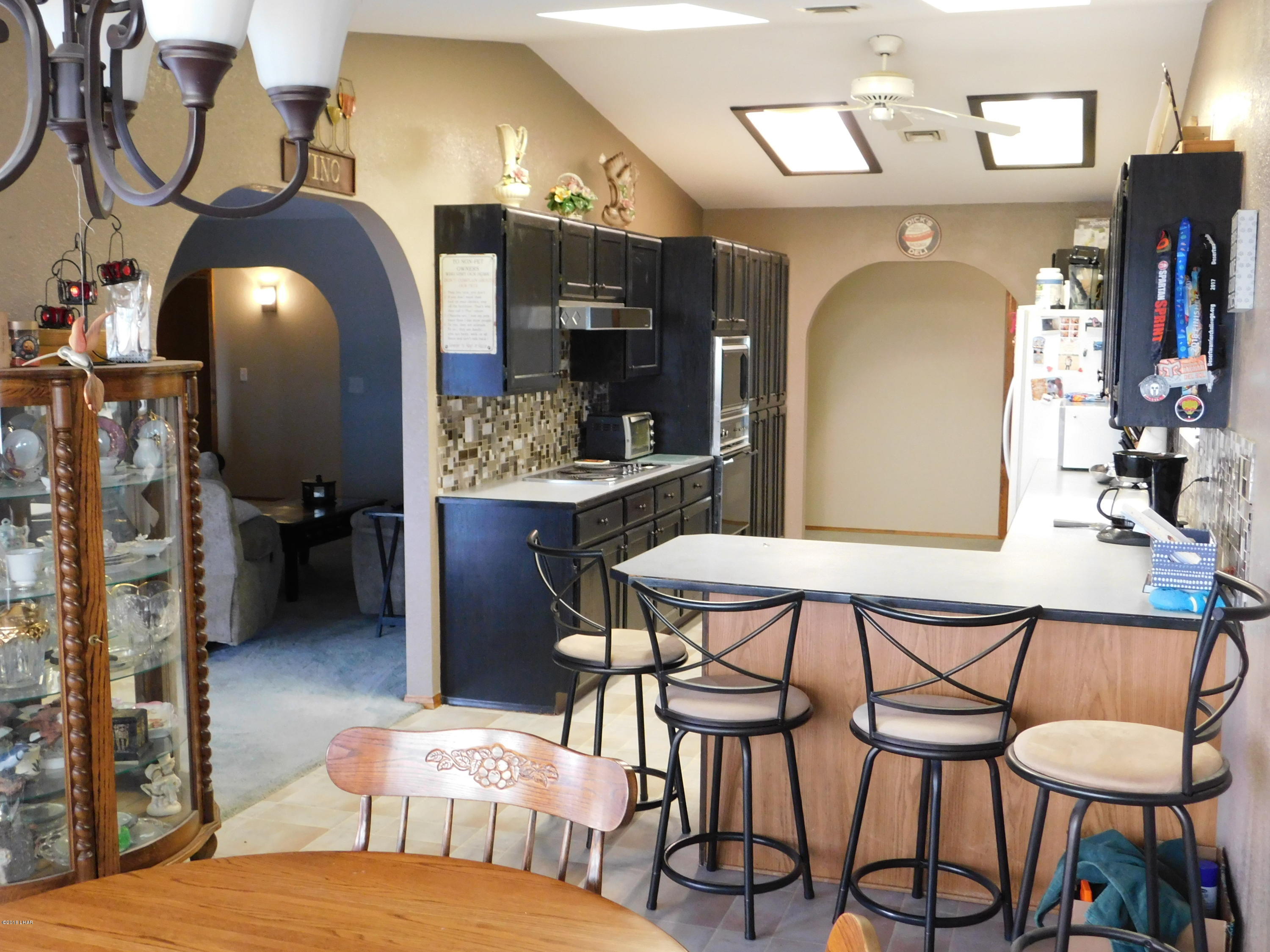 4010 Bluegrass Drive, Unit R Lake Havasu City, AZ 86406 - Photo 15 of 47 a bedroom with a bed and a chandelier