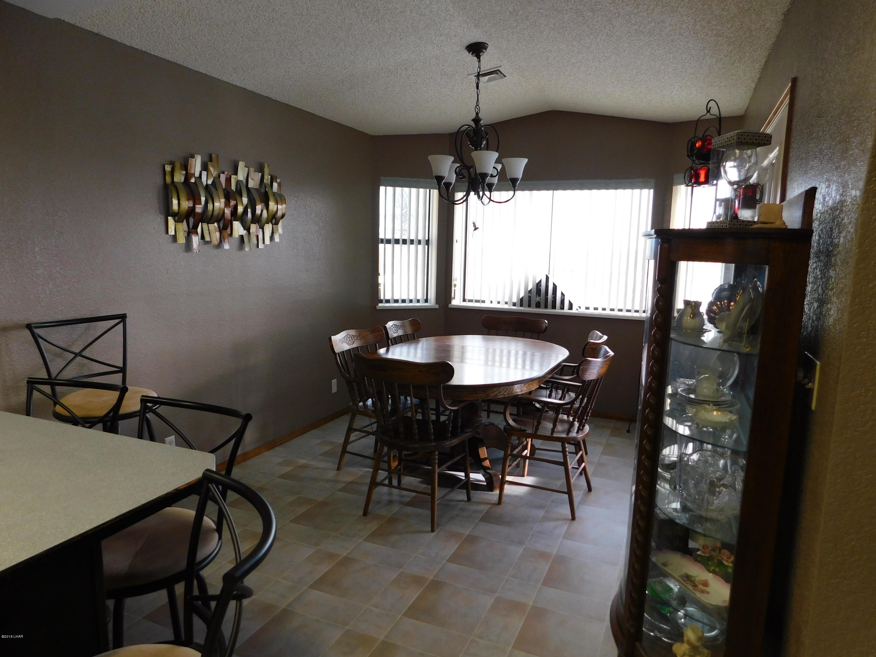 4010 Bluegrass Drive, Unit R Lake Havasu City, AZ 86406 - Photo 16 of 47 a view of a dining room with furniture window and outside view
