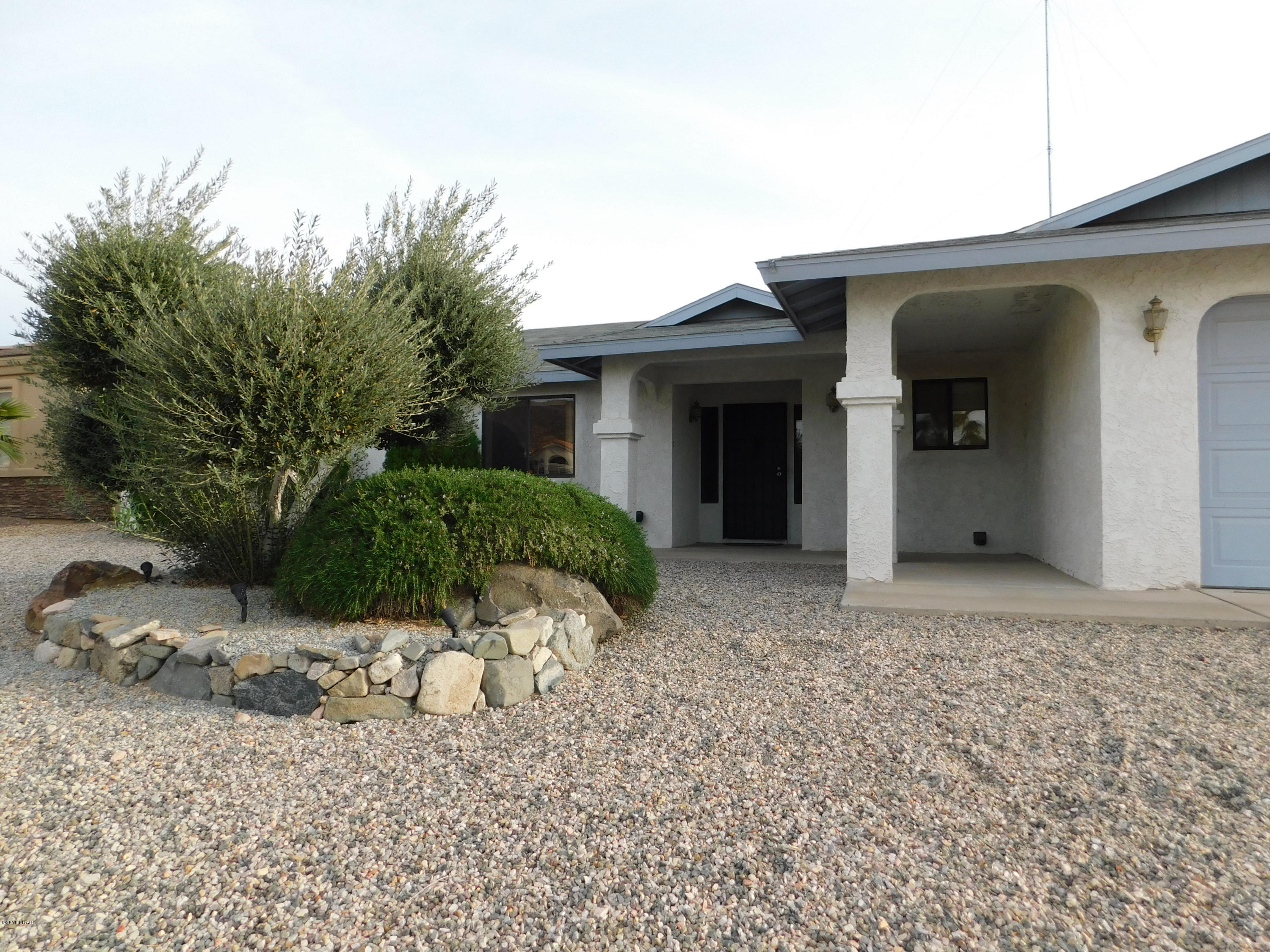 4010 Bluegrass Drive, Unit R Lake Havasu City, AZ 86406 - Photo 2 of 47 a view of a house with a yard and large tree