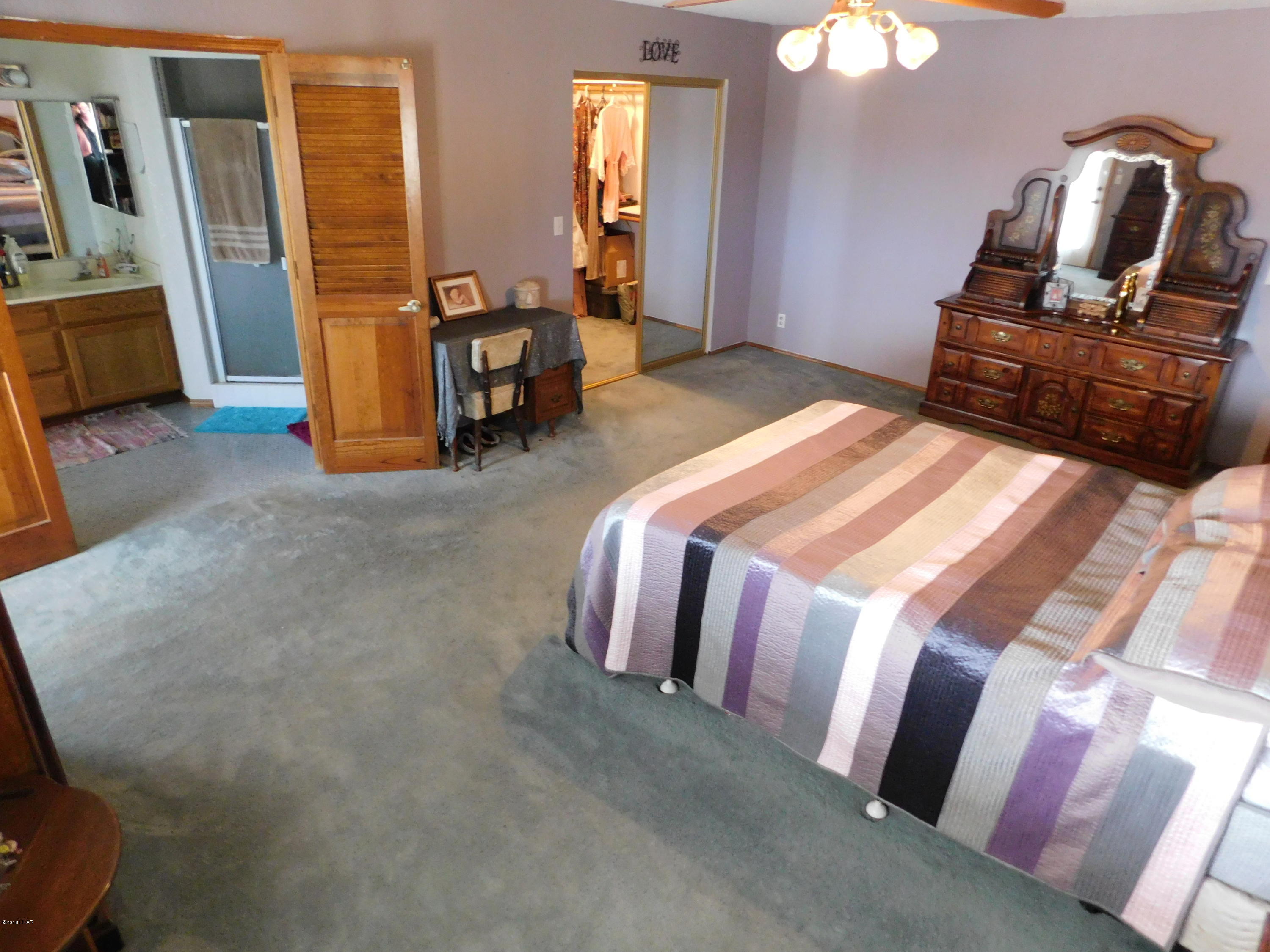 4010 Bluegrass Drive, Unit R Lake Havasu City, AZ 86406 - Photo 24 of 47 a bedroom with bed and wooden floor
