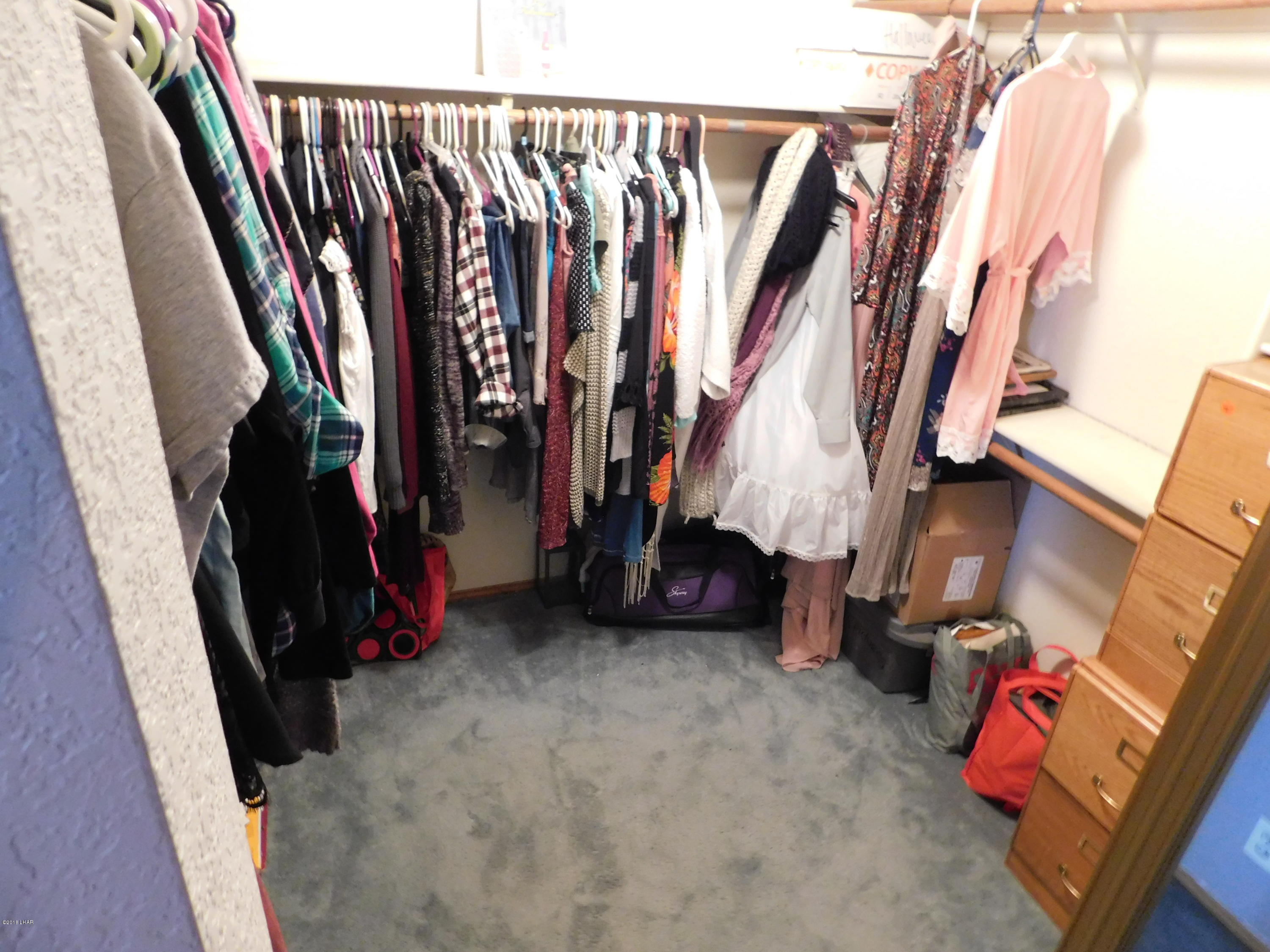 4010 Bluegrass Drive, Unit R Lake Havasu City, AZ 86406 - Photo 25 of 47 a view of walk in closet with clothes and shoes