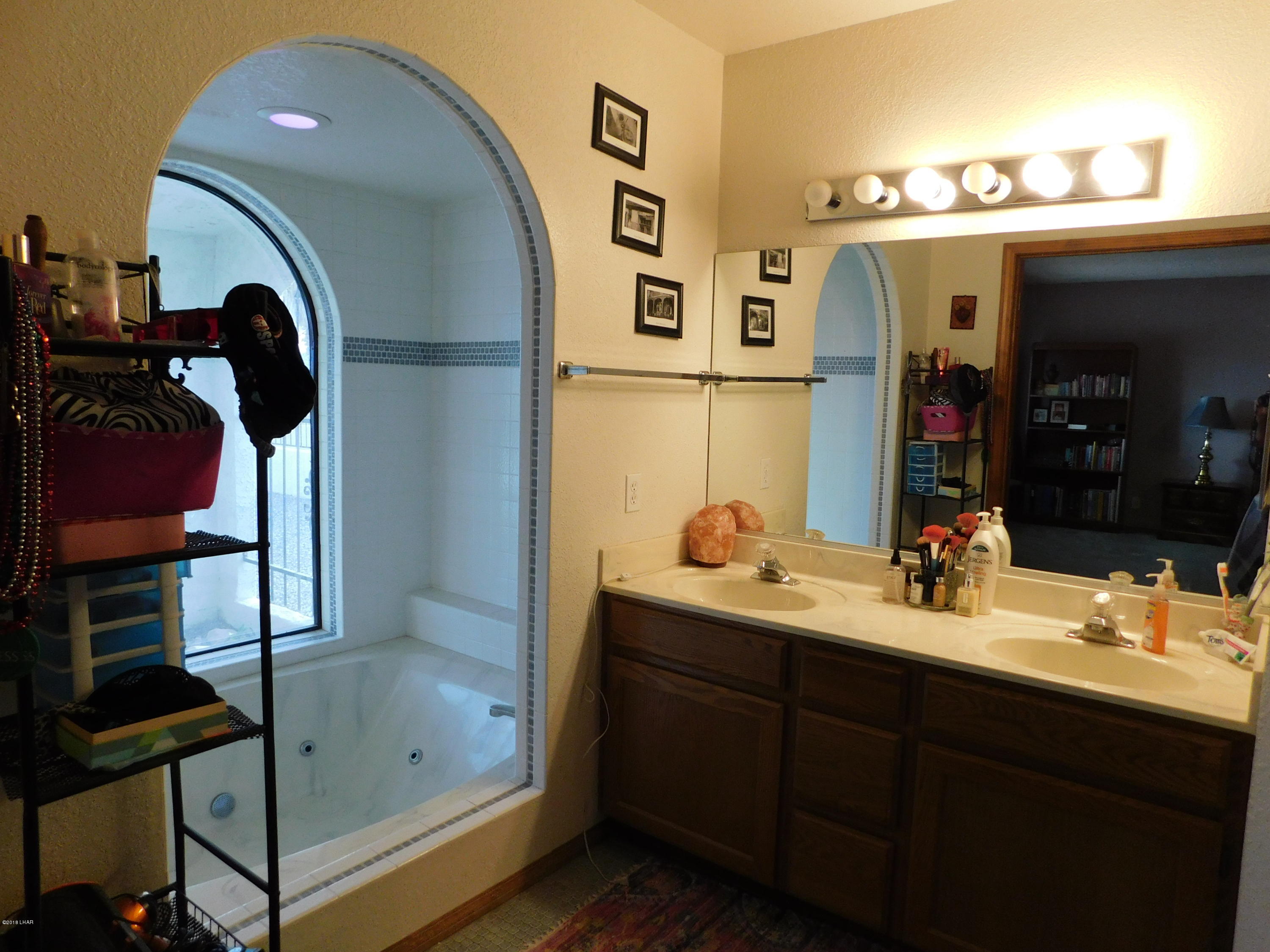 4010 Bluegrass Drive, Unit R Lake Havasu City, AZ 86406 - Photo 26 of 47 a bathroom with a sink and a mirror