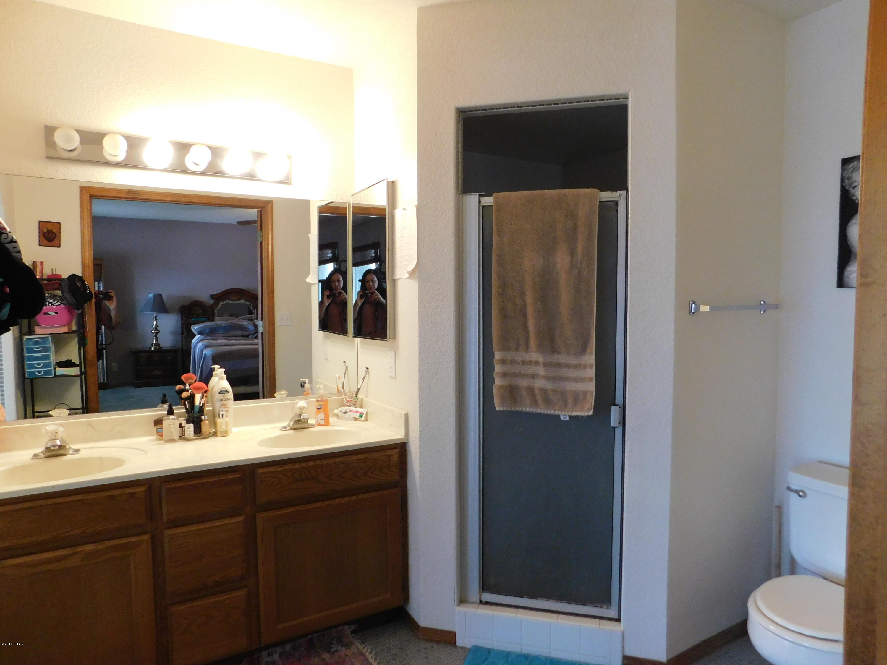 4010 Bluegrass Drive, Unit R Lake Havasu City, AZ 86406 - Photo 27 of 47 a bathroom with a sink a toilet and shower