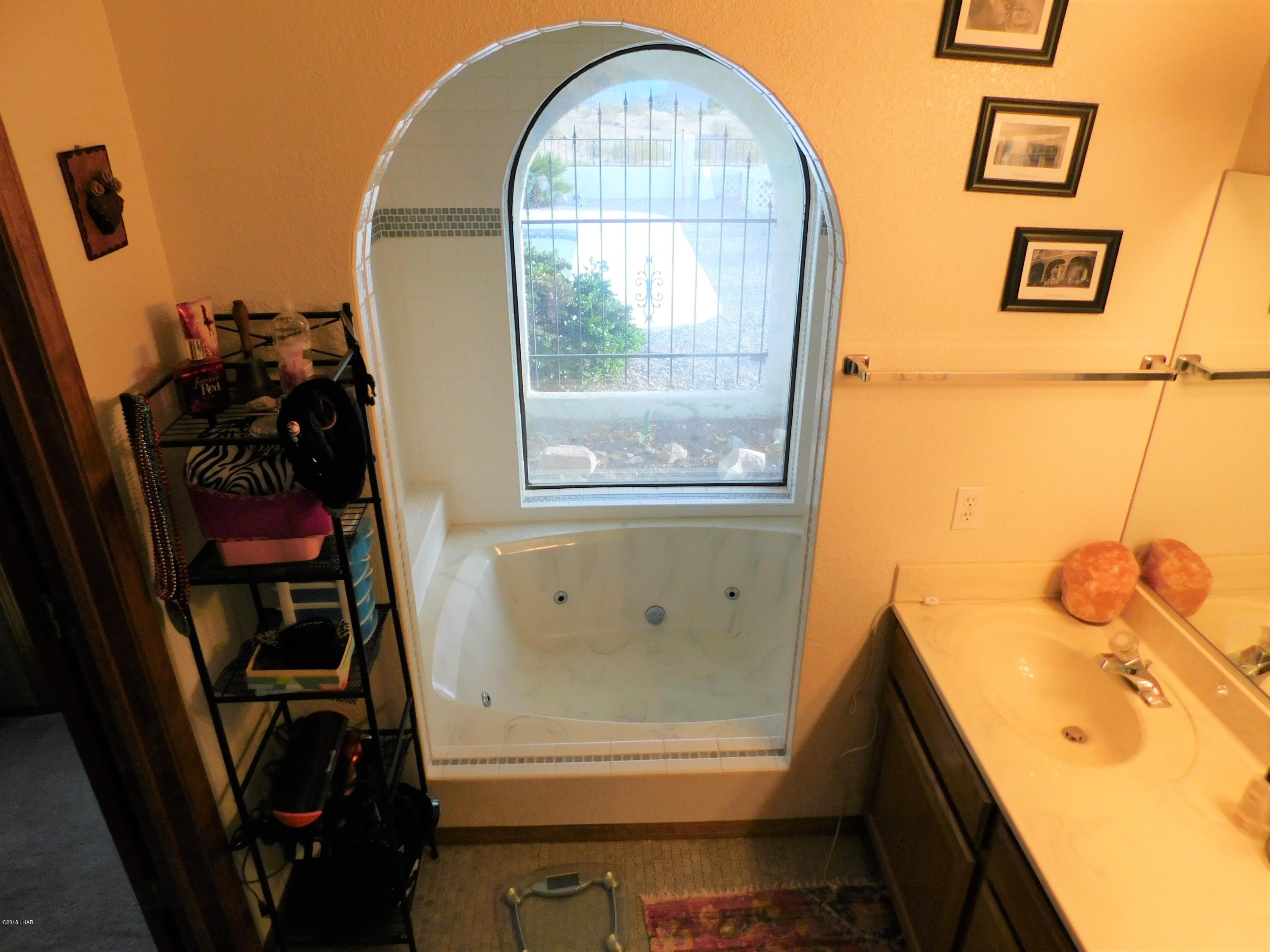 4010 Bluegrass Drive, Unit R Lake Havasu City, AZ 86406 - Photo 28 of 47 a bathroom with a sink and a mirror
