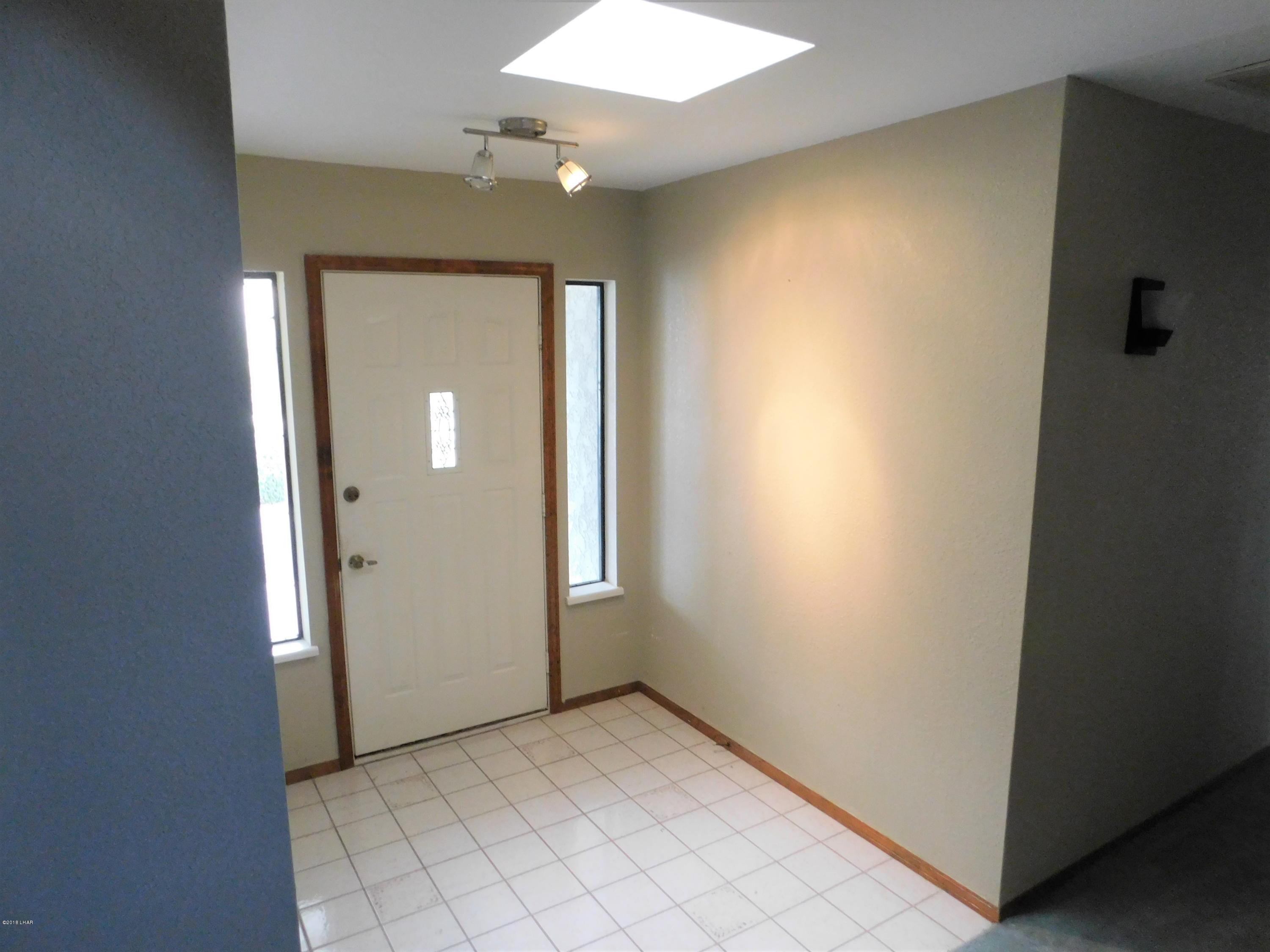 4010 Bluegrass Drive, Unit R Lake Havasu City, AZ 86406 - Photo 4 of 47 an empty room with windows and closet