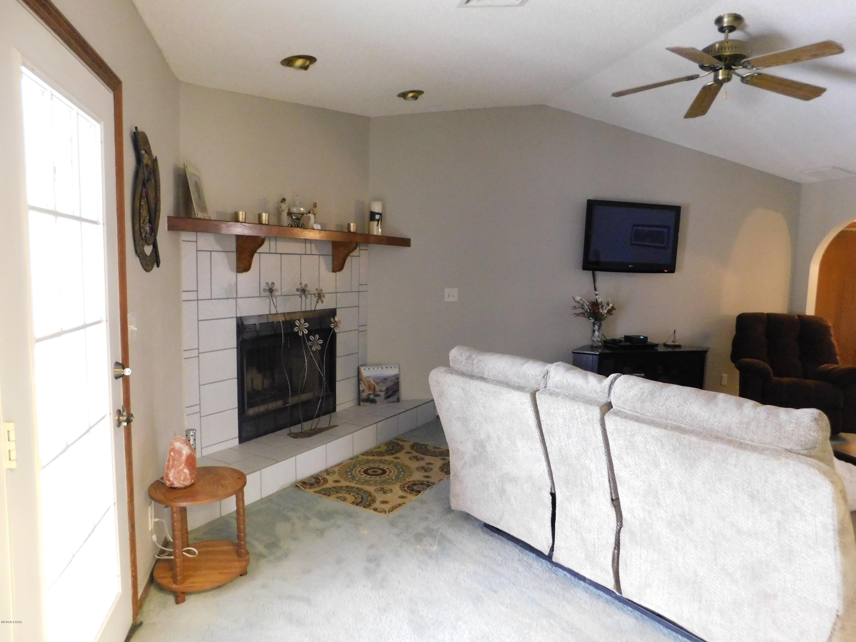 4010 Bluegrass Drive, Unit R Lake Havasu City, AZ 86406 - Photo 8 of 47 a living room with furniture and a fireplace